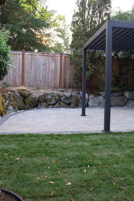 New lawn in the foreground with the paved patio beyond