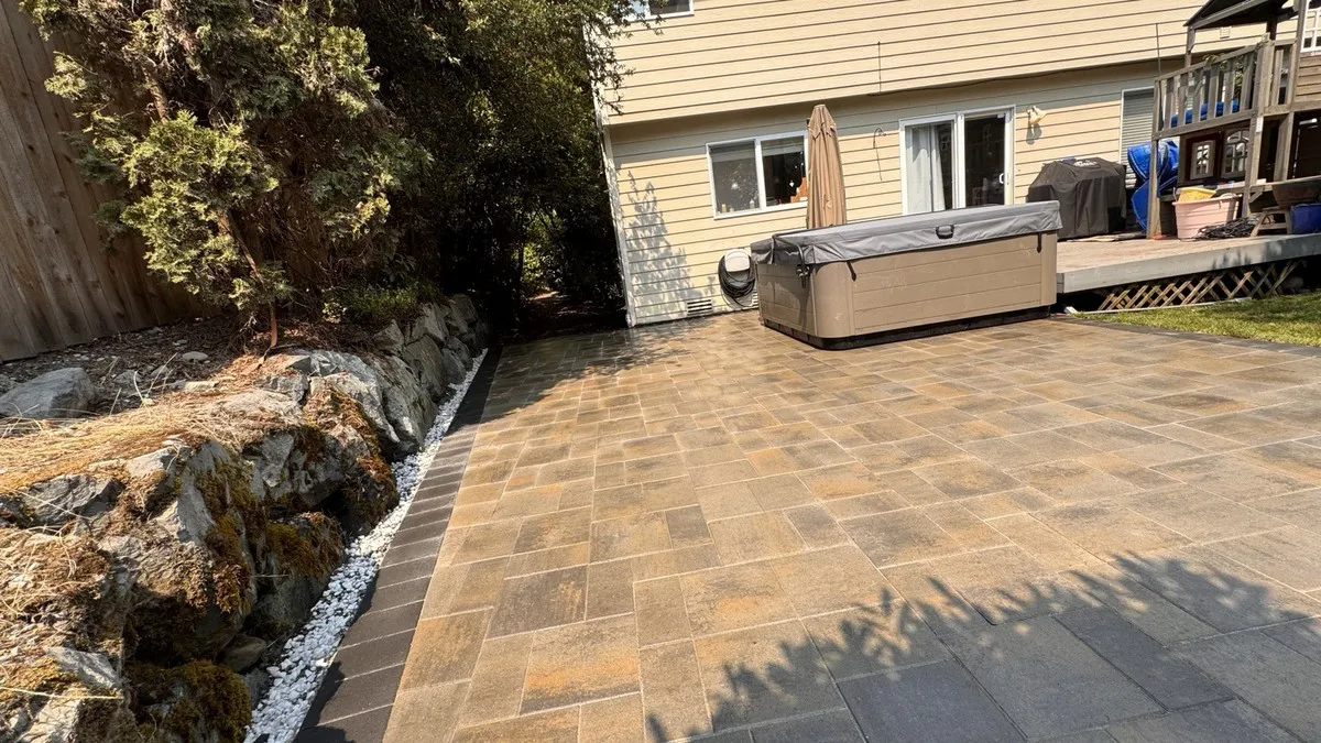 Patio running along the rock-lined planting bed