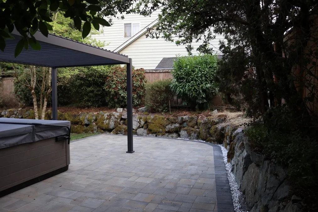Paver surface beside the rock-lined planting bed